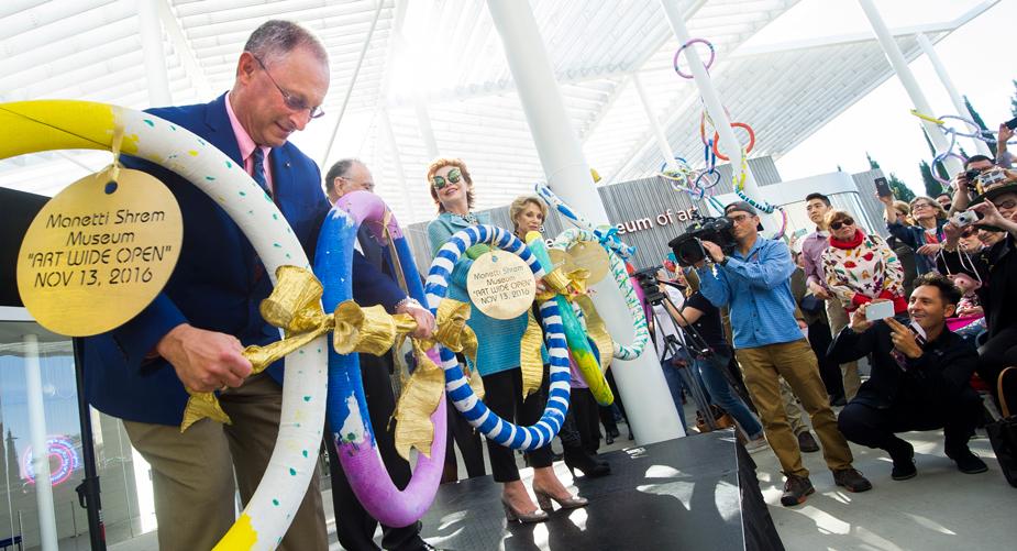 Ralph Hexter unties ribbon connecting chain at Shrem Museum grand opening.