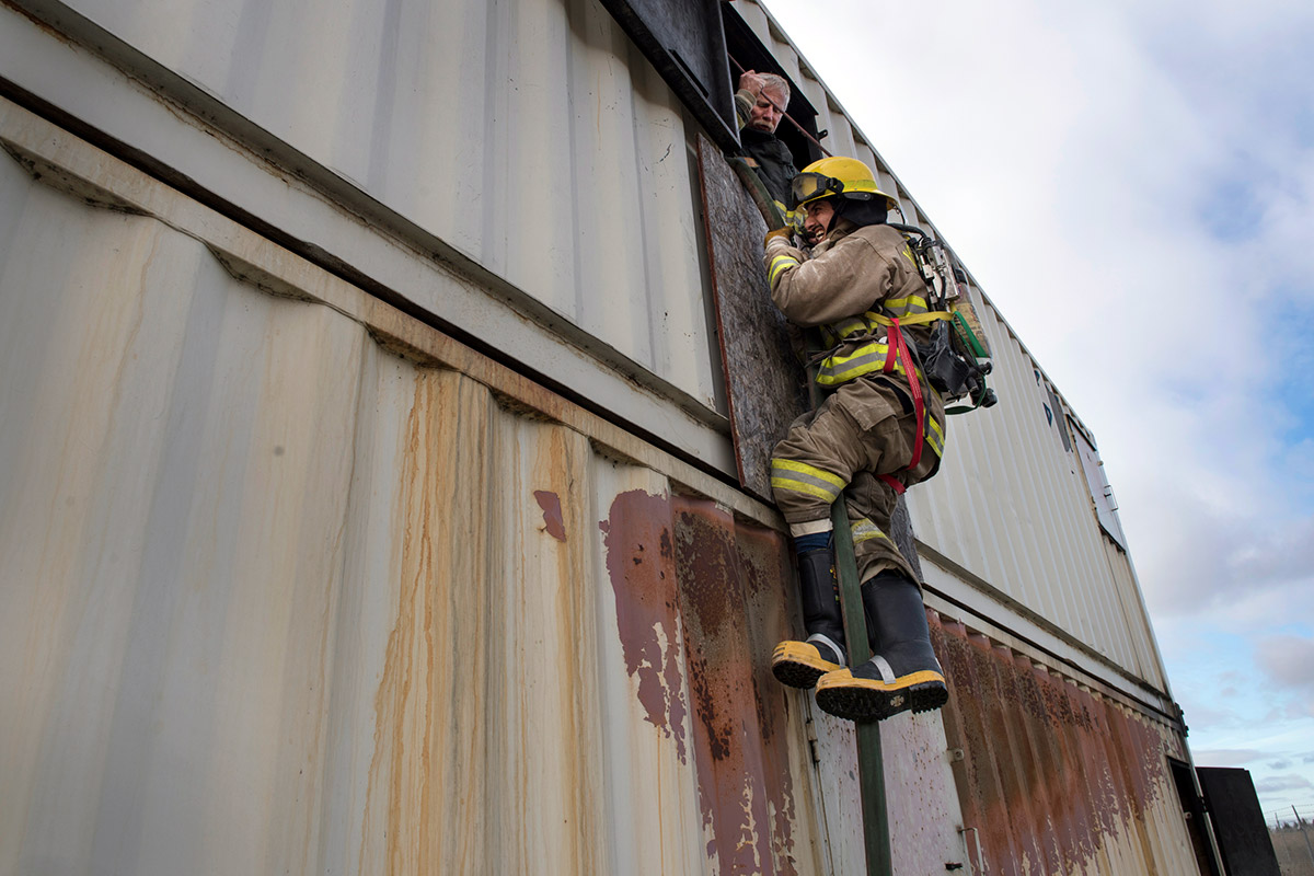 Firefighter climbing during training