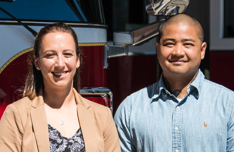 New firefighters Johnita Lanni-Cradit and Chris Lujan in front of firetruck
