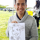 Man holds caricature of himself at UC Davis