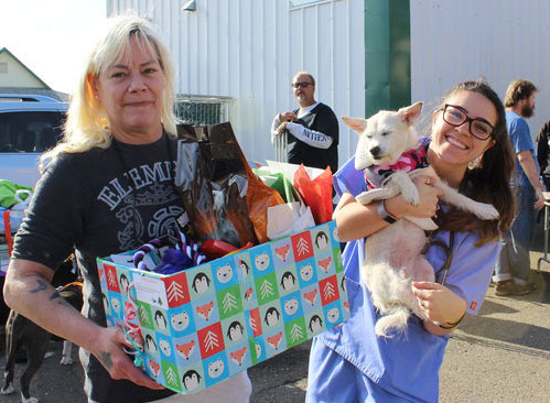 Woman and dog receive Holiday Pet Basket
