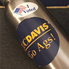 A water bottle with UC Davis and "I voted" stickers.
