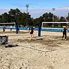Beach volleyball courts in use.