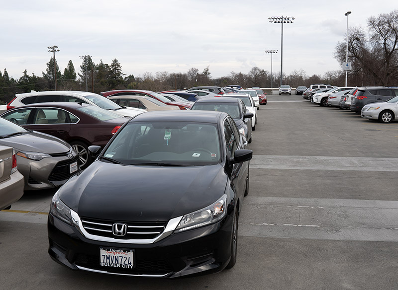 Cars parked in a stack parking arrangement.