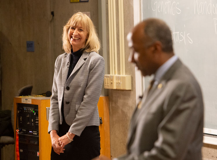 Professor Oberbauer in front of lecture hall, Chancellor May at lectern