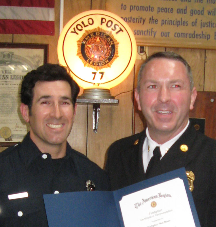 Fire chief presents certificate to firefighter.