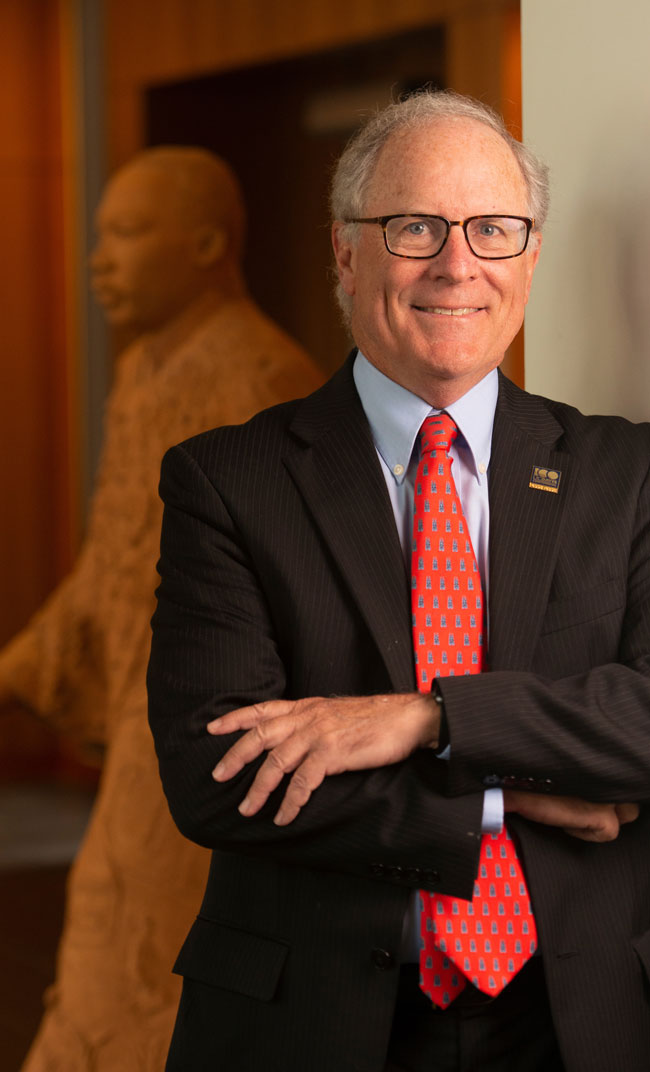 Stephen Boutin poses in front of Martin Luther King Jr. sculpture.