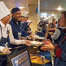 LeShelle May and Chancellor Gary S. May serve food to students.