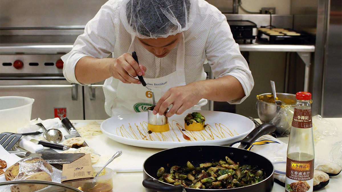 A cook works on a dish at the 2016 cooking competition.
