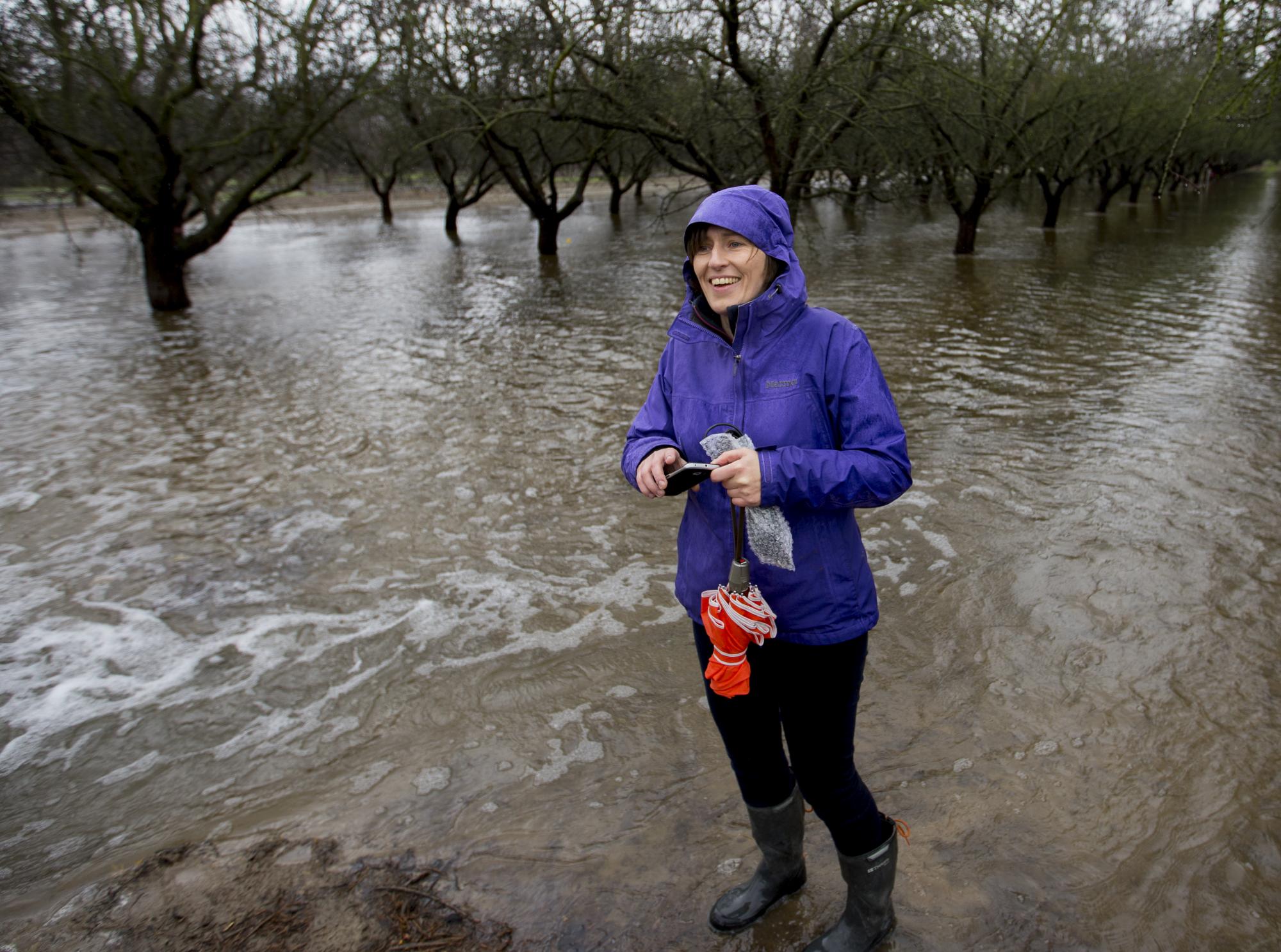 Female scientists in almond orchard being flooded for groundwater research.