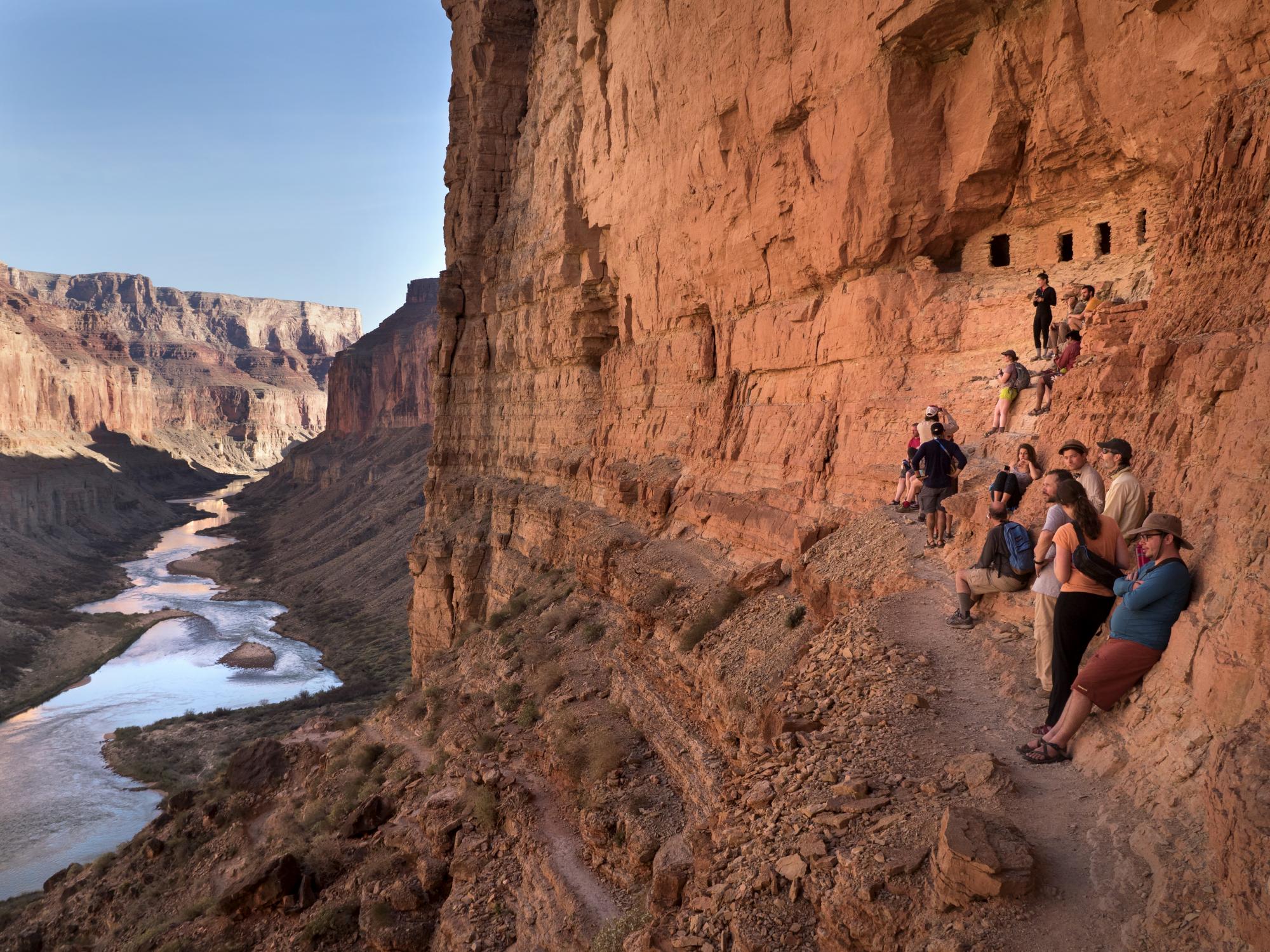 University students at Nankoweap granary ruins, overlooking Colorado River in Grand Canyon