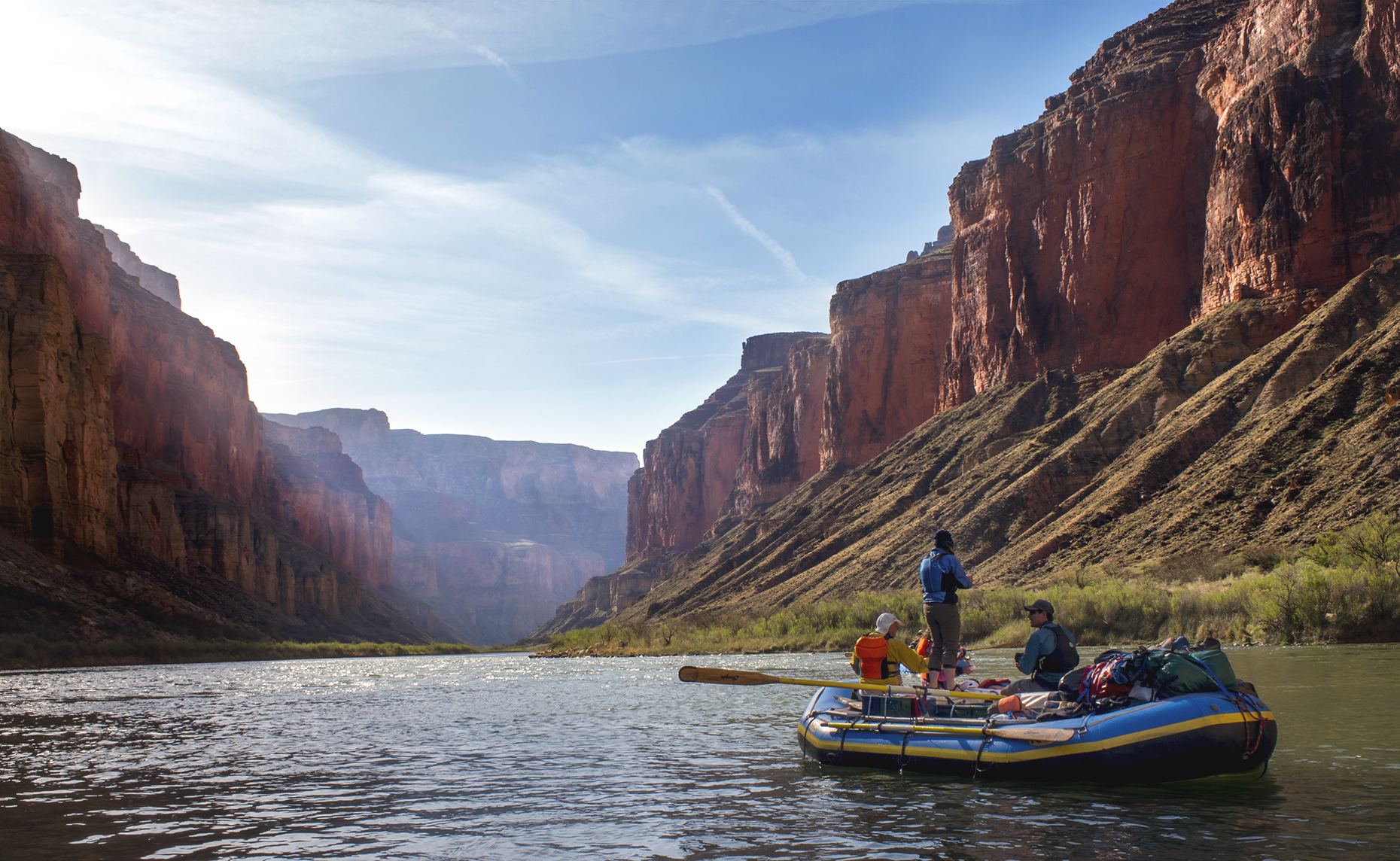 Two men and woman in raft in Grand Canyon