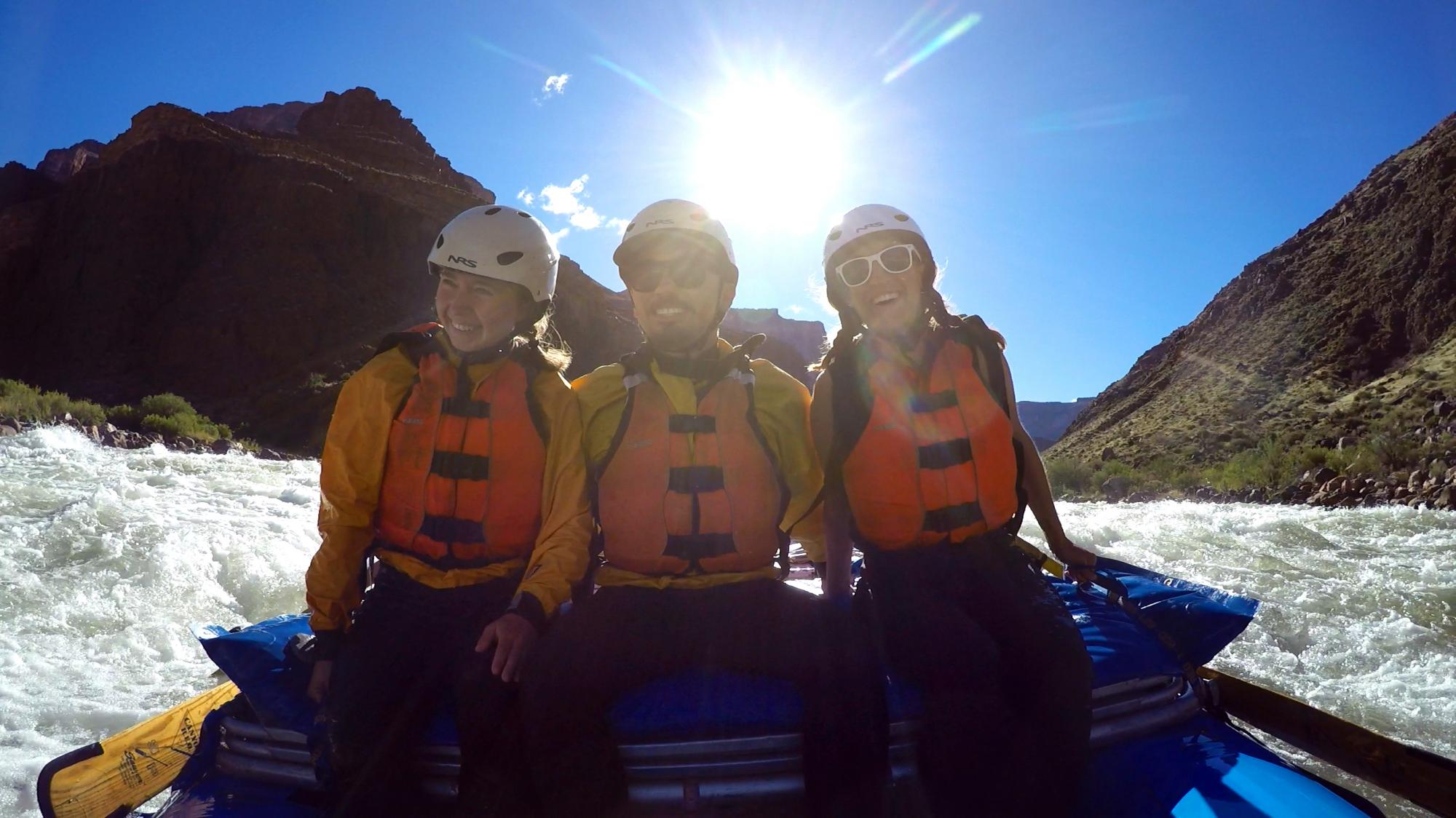 Two women and a man whitewater raft
