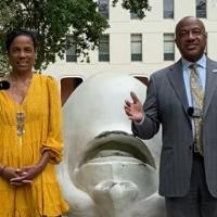 Chancellor Gary May and LeShelle standing in front of the Eye on Mrak (Fatal Laff) Egghead