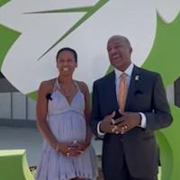 Chancellor Gary May and LeShelle standing in front of the newly built The Green at West Village