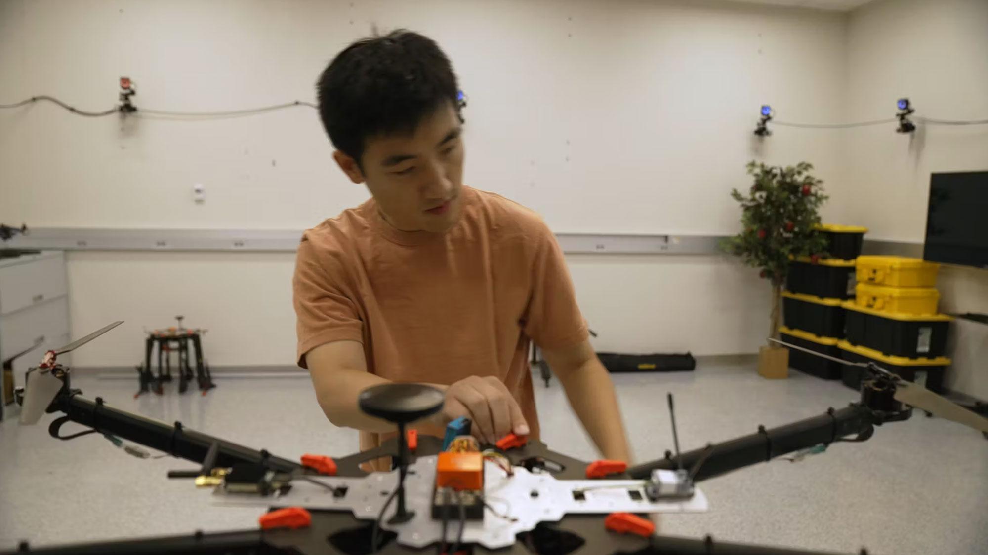 a researcher working on a wildfire monitoring drone in a lab
