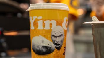 A yellow Yin & Yang Eggheads cup sits on the front counter of Spokes Grill.