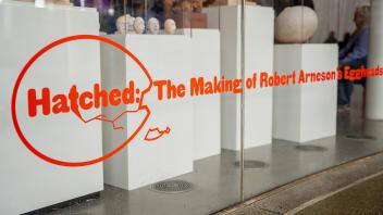 “Hatched: The Making of Robert Arneson’s Eggheads” is emblazoned in red on a glass wall at the front of the Manetti Shrem Museum.