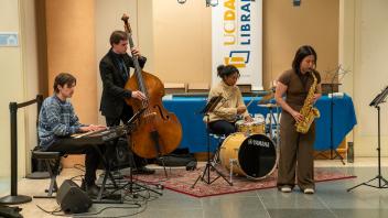 A four member jazz band performs in Shields Library during the Year of the Eggheads VIP celebration.