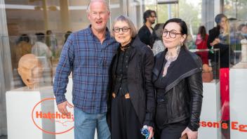 The Arneson family, Kirk Arneson, Sandra Shannonhouse, and Tenaya Arneson, smile at the camera during the Year of the Eggheads VIP celebration.