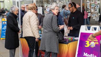 Three women check in at the Year of the Eggheads VIP celebration.