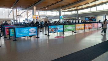 Multi-colored line dividers promote the Arneson Egghead Collection at the Sacramento Airport.