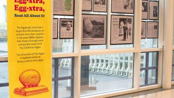 Newspaper clippings from The Aggie discussing Arneson and the Eggheads are displayed on the windows of Shields Library.