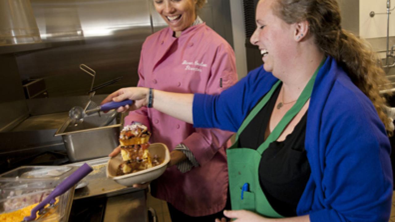 Photo: Sharon Coulson, Coffee House director, and Lauren Woods, CoHo South Cafe, manager, making a Quad Stack.