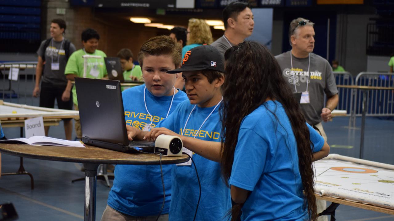 Students with robot and laptop