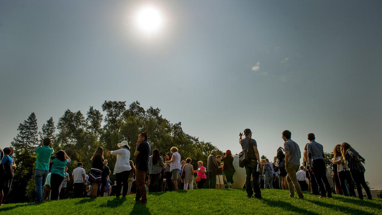 A crowd watches the eclipse.