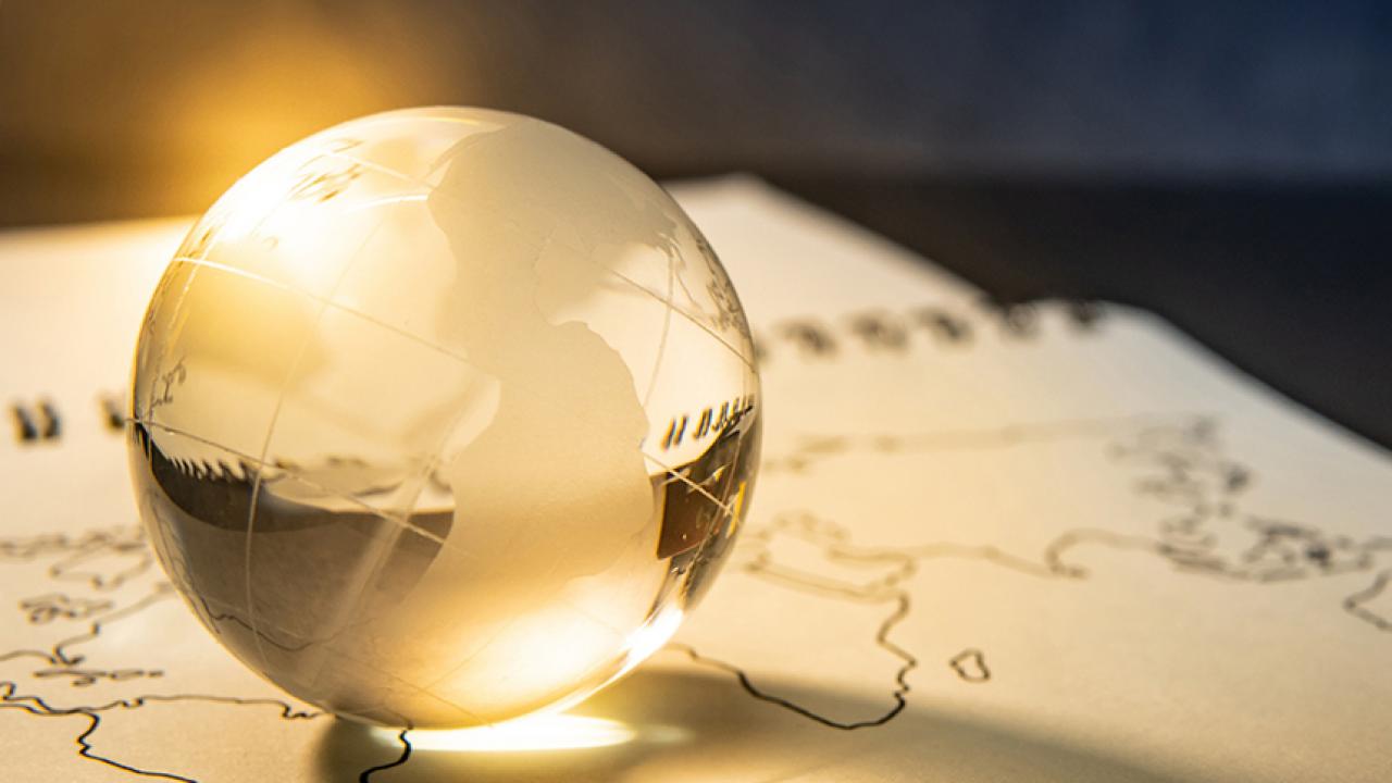 A gold-tinged glass globe on a world map
