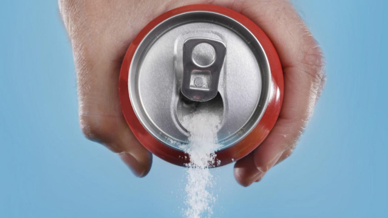 Photo of sugar pouring out of soda can