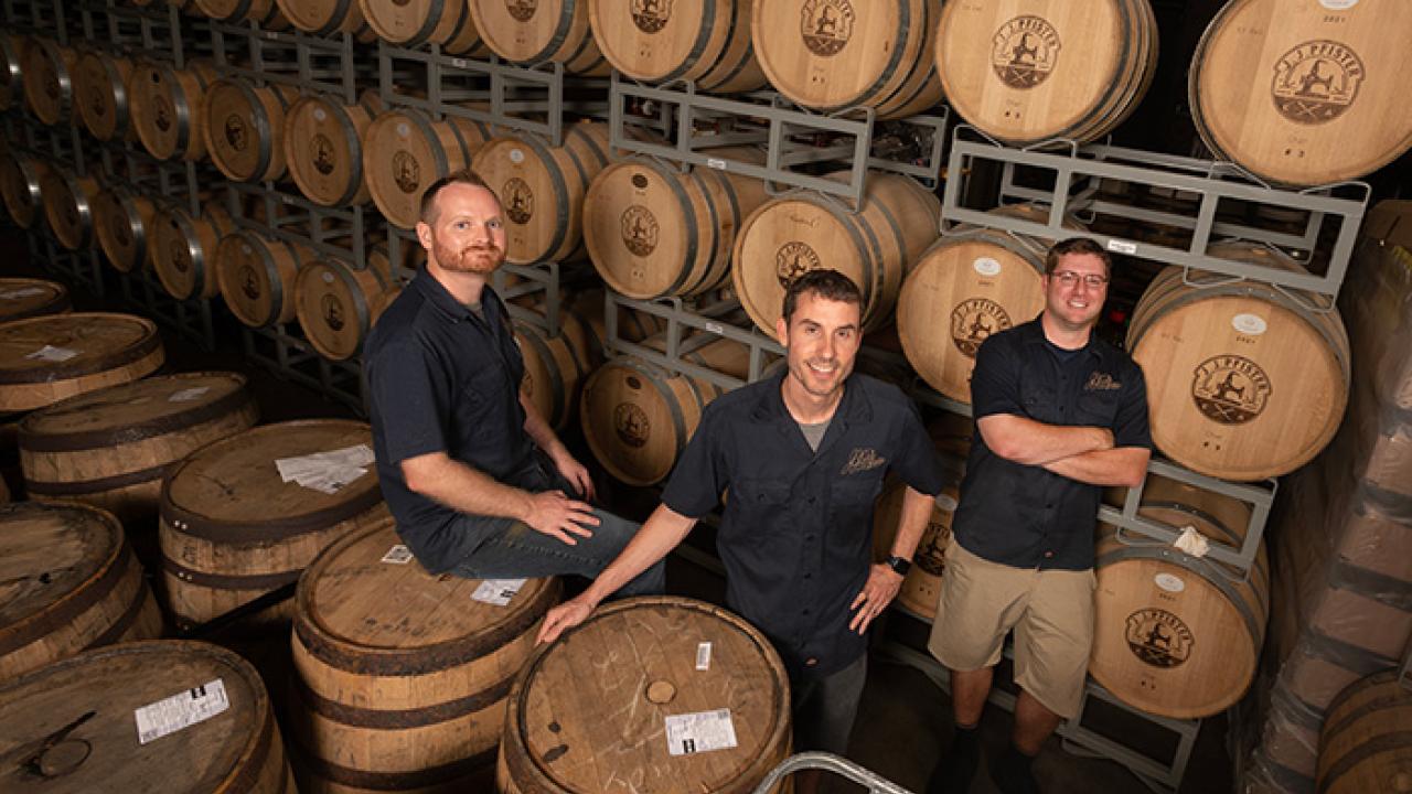 Left to right: Brian Keck, M.S. ’16, Chris Johnson, M.S. ’16, and Michael Moore ’09, M.A. ’11, are the distillers behind Sacramento-based J.J. Pfister Distilling. (Gregory Urquiaga)