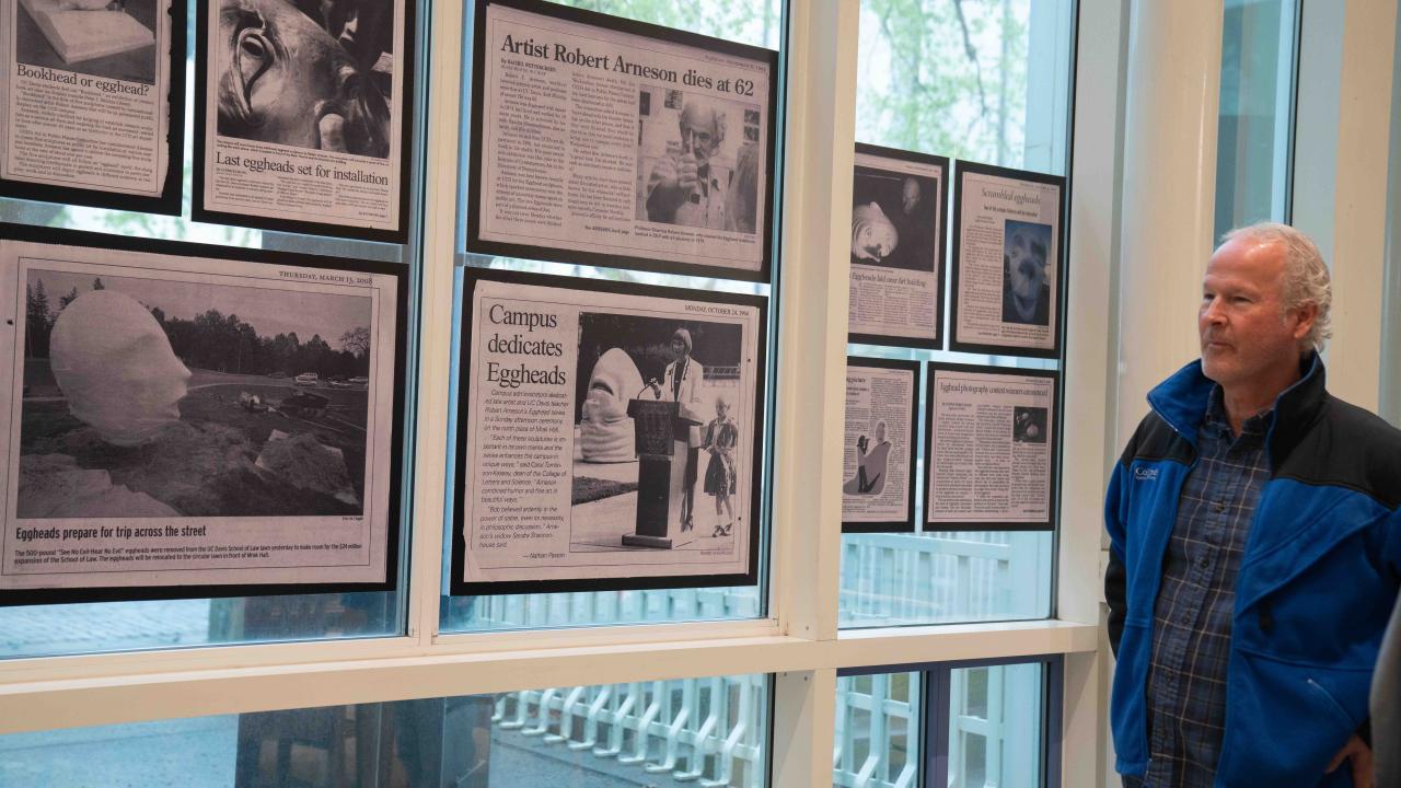 Kirk Arneson, son of artist Robert Arneson, views the display in Shields Library featuring archival photos and stories