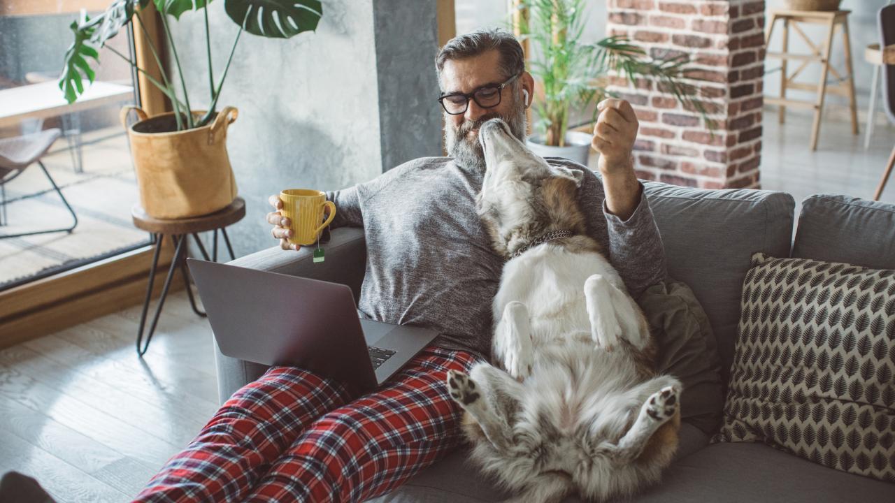 Man sitting on couch with dog