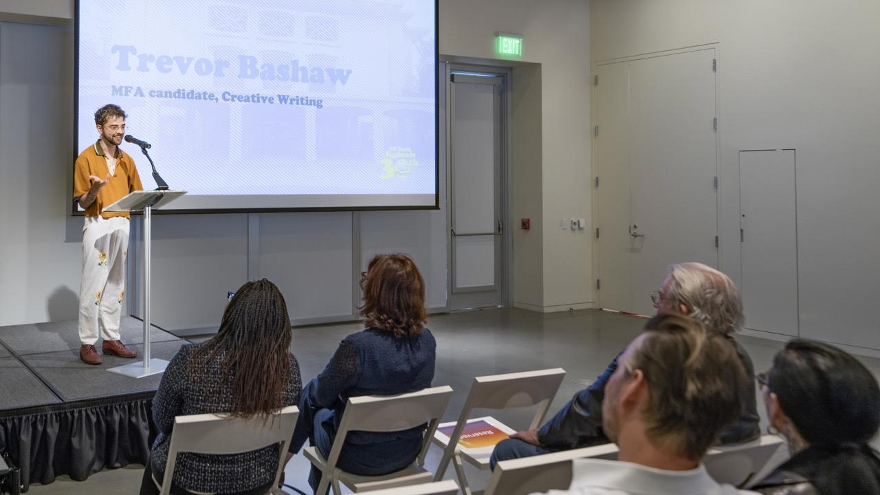 On the April 4 2024 "EGGHEADS BIRTHDAY CAMPUSWIDE CELEBRATION" MFA candidate Trevor Bashaw reads his poem before a group of celebrants 