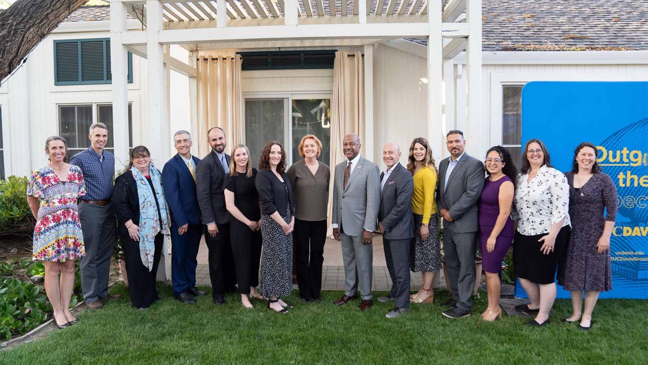 Group of people pose in courtyard of chancellor’s residence.