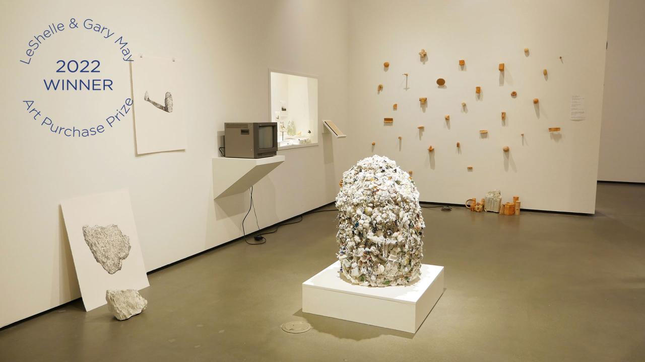 Winning exhibit features white-themed sculptures and wall art, including large white sphere in middle