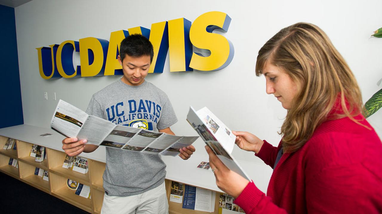 Students read brochures at the UC Davis Welcome center