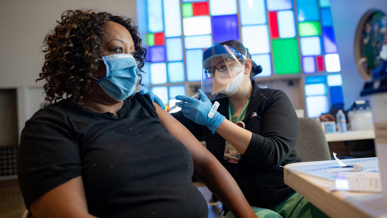 Woman receives vaccine in church.