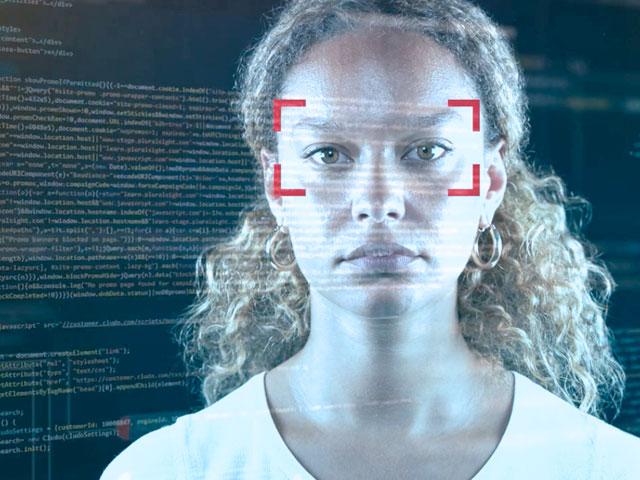 A female face covered in code and a red square target