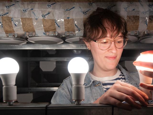 A female UC Davis researchers examines some new lighting technology
