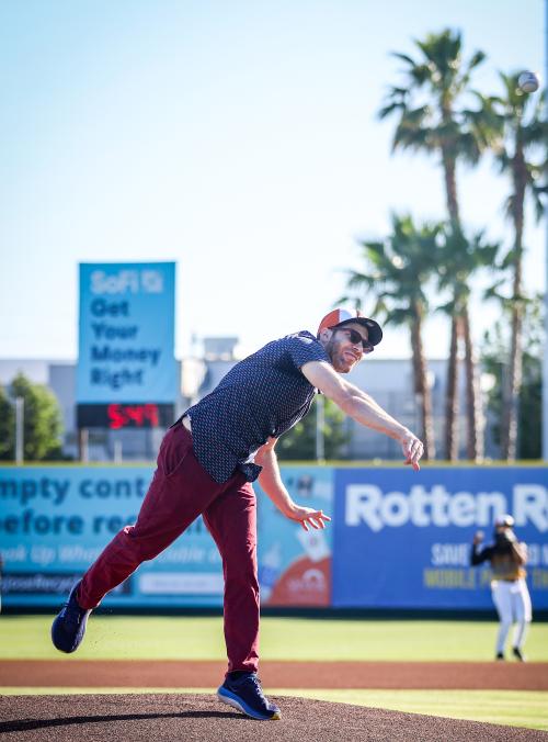 Man throws first pitch at baseball game