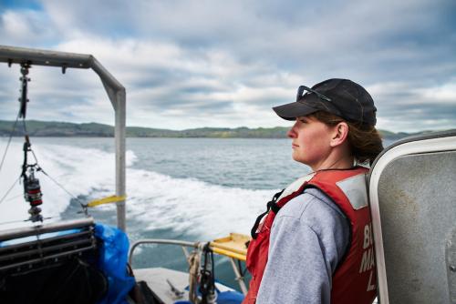 Profile of woman in cap on boat in ocean