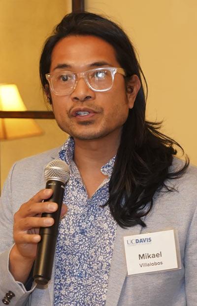 Man at podium, speaking, with microphone in hand