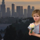 Book cover, cropped, showing little girl holding a flower, with polluted cityscape in background.