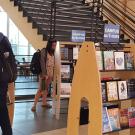 Library patrons peruse "Campus Authors" display.