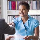 Six must-have skills career HR, a woman shakes hands at a job interview.