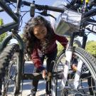 UC Davis student Sidra Ali locks up her bicycle.