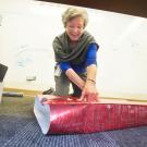 Jo Anne Boorkman, of Academic Affairs, wraps a gift collected for STEAC in 2014.